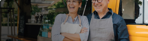 Man and woman wearing aprons smiling