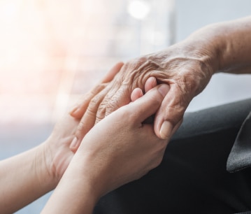 A closeup of two hands holding an elderly hand