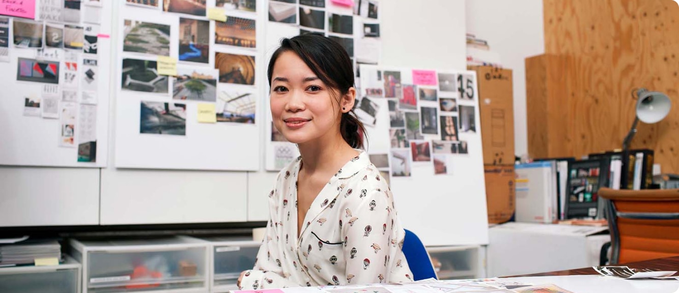 Woman sitting in an office smiling at the camera